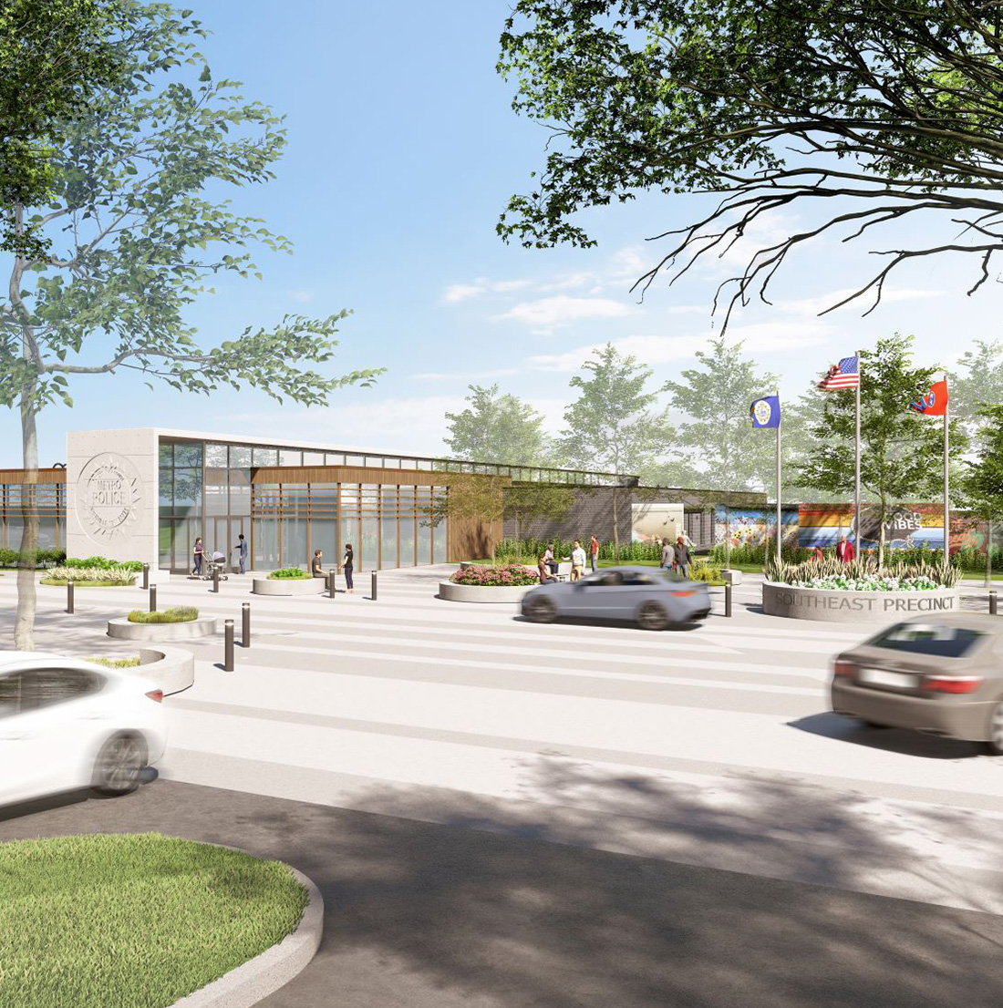 Wide-angle view of the precinct’s front entrance with multiple people approaching or gathered around the building, vehicles in motion, and a mural visible behind a row of flags.