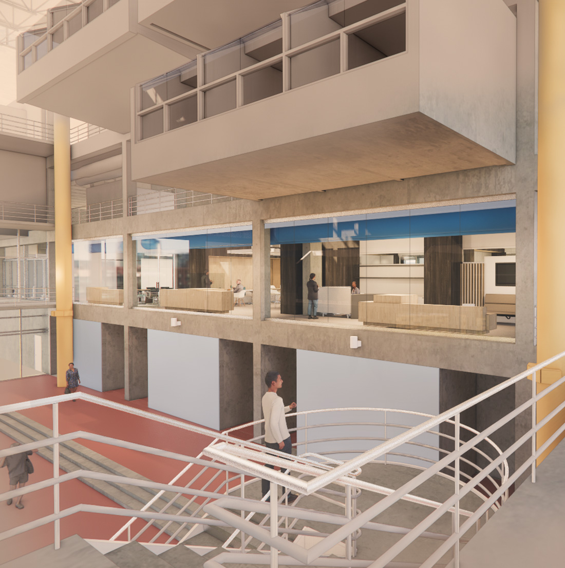 View from a central atrium staircase looking up toward a mezzanine of office suites with glass walls. The modern design features exposed concrete, colorful flooring, and yellow vertical columns, with people walking and interacting across multiple levels.
