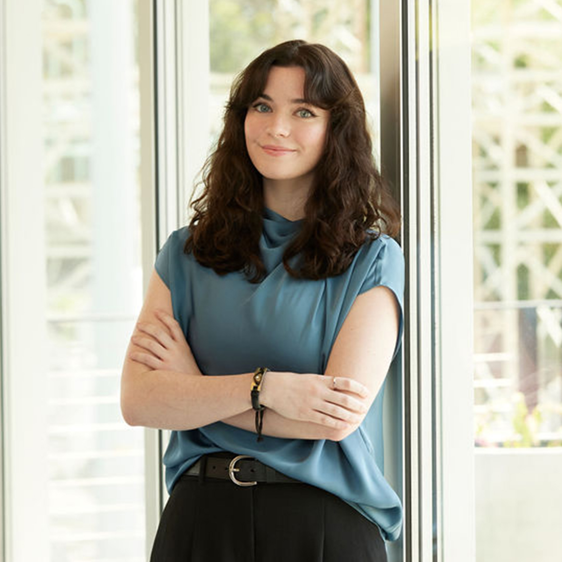 Kelsey Cox's headshot in the Smith Gee Studio office.